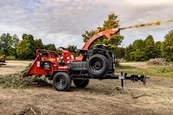 New Brush Chipper waiting in field,New Morbark working in a field